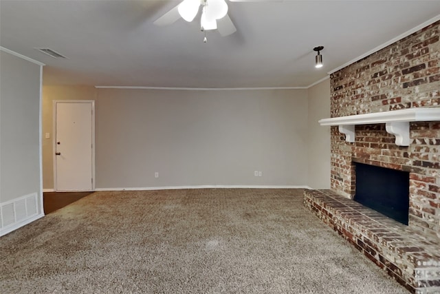 unfurnished living room featuring crown molding, ceiling fan, carpet floors, and a brick fireplace