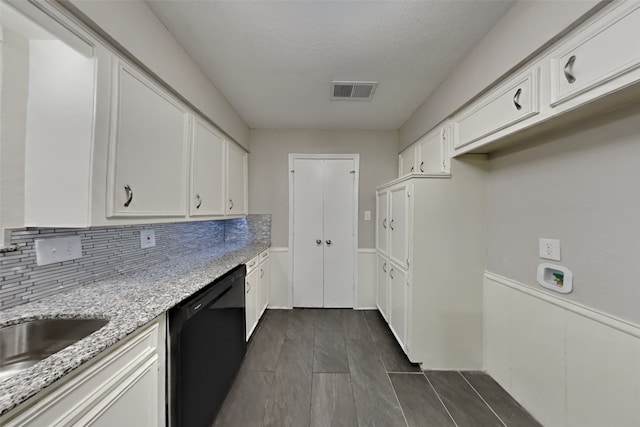 kitchen with light stone counters, a textured ceiling, dishwasher, white cabinets, and backsplash