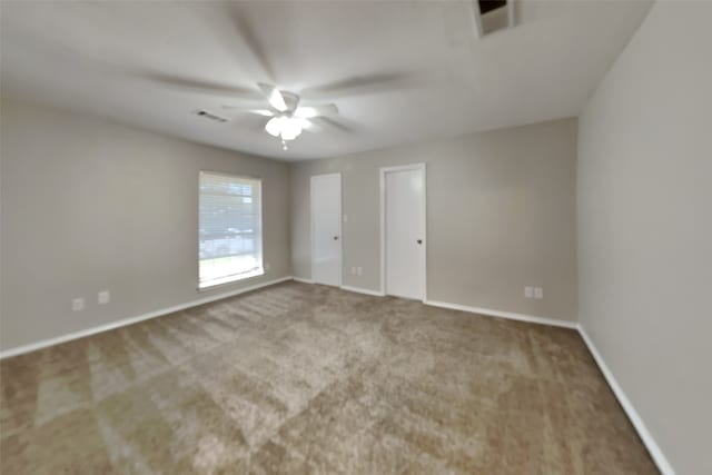 empty room with ceiling fan and carpet