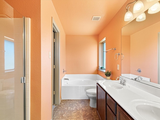 full bathroom featuring vanity, a wealth of natural light, a textured ceiling, independent shower and bath, and toilet