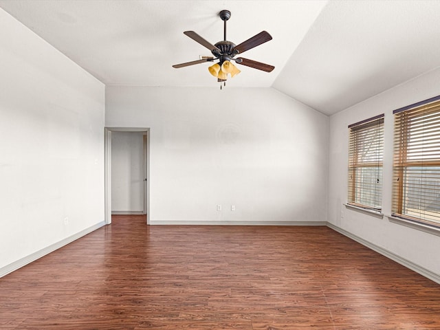 empty room featuring ceiling fan, lofted ceiling, and dark hardwood / wood-style flooring