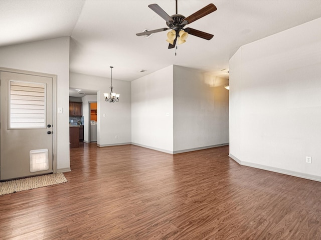 unfurnished living room with dark wood-type flooring, vaulted ceiling, and ceiling fan with notable chandelier