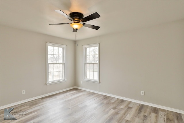 spare room with ceiling fan and light wood-type flooring