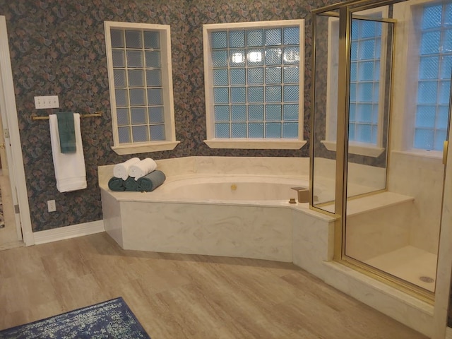 bathroom featuring hardwood / wood-style floors and separate shower and tub