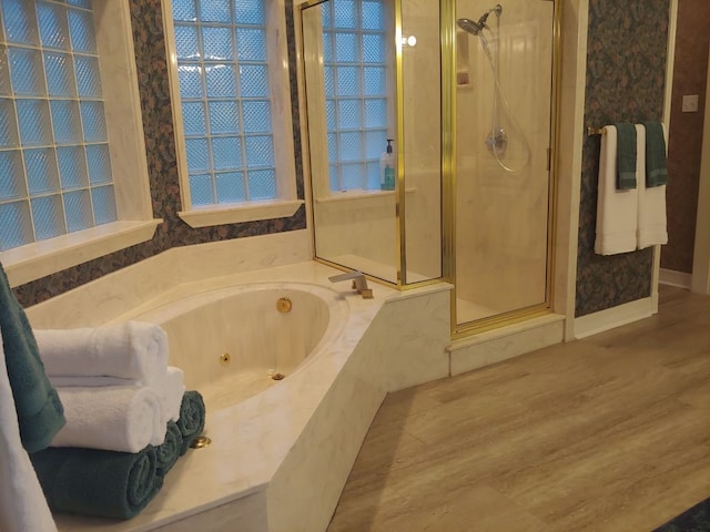 bathroom featuring wood-type flooring and independent shower and bath