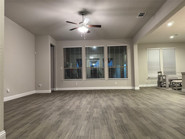 spare room featuring dark wood-type flooring and ceiling fan