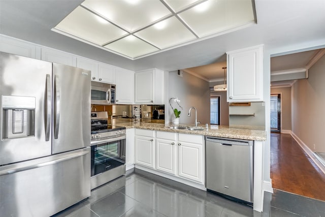 kitchen with sink, ornamental molding, stainless steel appliances, light stone countertops, and white cabinets