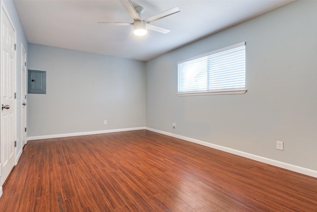 empty room with ceiling fan, dark hardwood / wood-style flooring, and electric panel