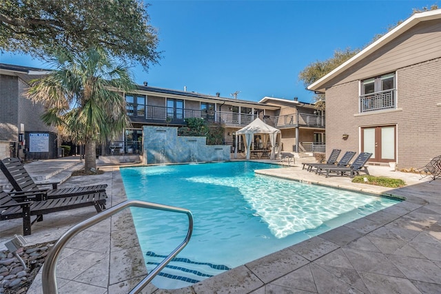 view of swimming pool with a patio and pool water feature