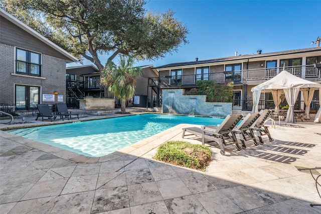 view of swimming pool featuring a patio area and pool water feature