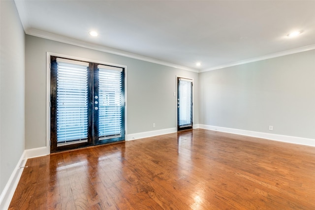 unfurnished room featuring hardwood / wood-style floors and ornamental molding