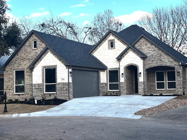 french country home with a garage