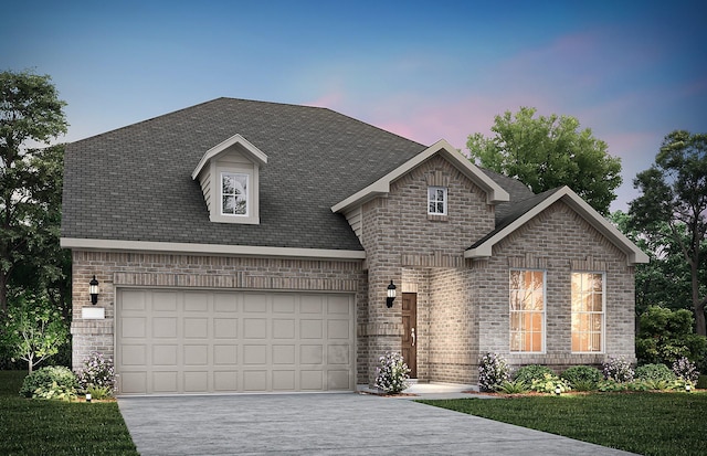 view of front of property with a garage and a lawn