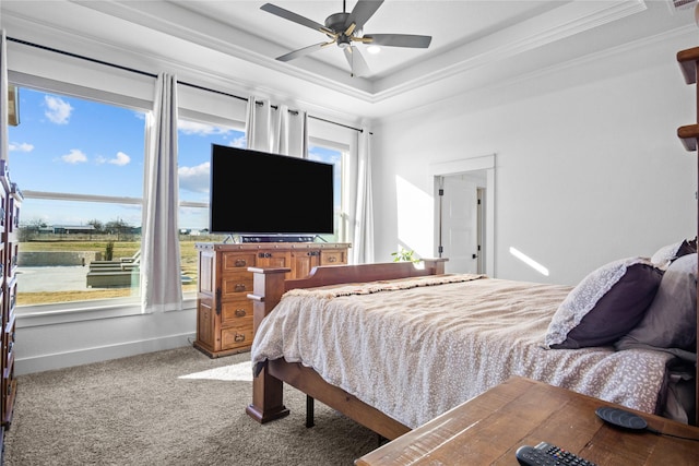 bedroom with multiple windows, crown molding, carpet flooring, and a tray ceiling