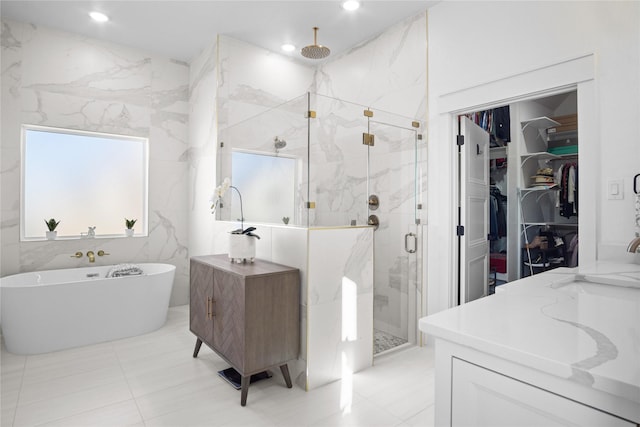 bathroom featuring vanity and separate shower and tub