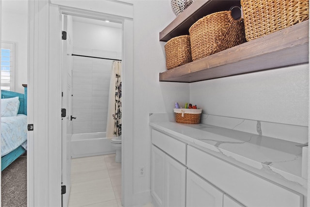 bathroom featuring tile patterned floors and shower / bathtub combination with curtain