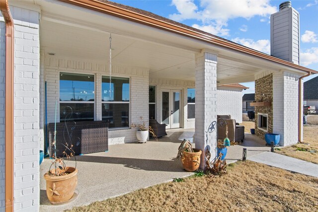 view of patio with an outdoor fireplace