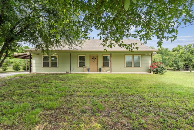 ranch-style home featuring a carport and a front lawn