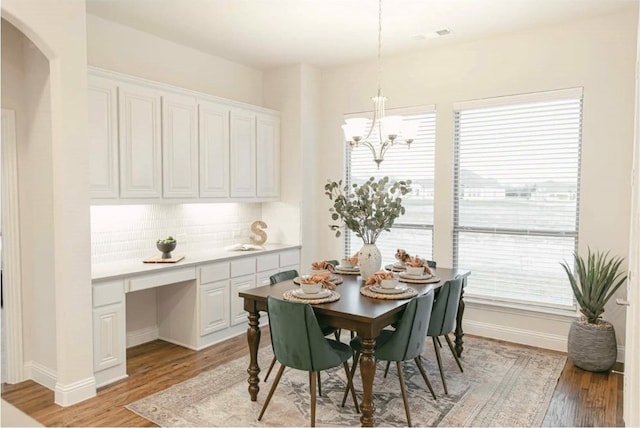 dining space featuring a notable chandelier and light hardwood / wood-style flooring