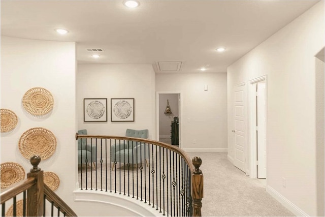 hallway featuring light colored carpet