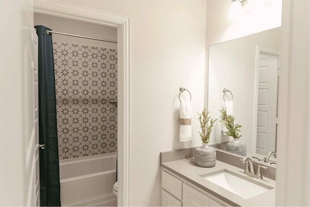 full bathroom featuring vanity, shower / tub combo, and toilet