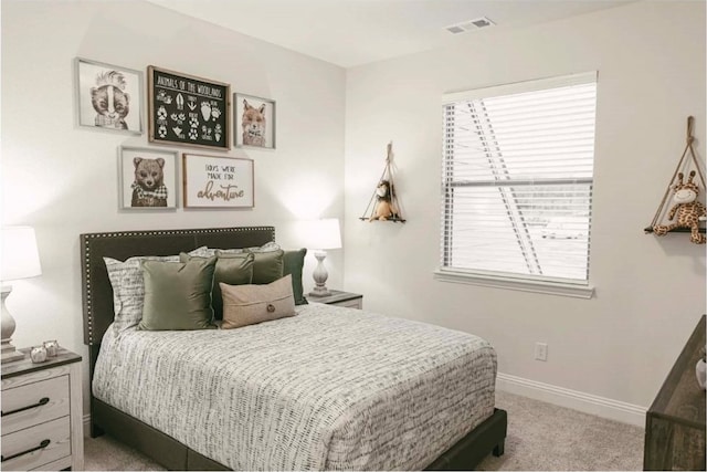 bedroom with multiple windows and carpet floors