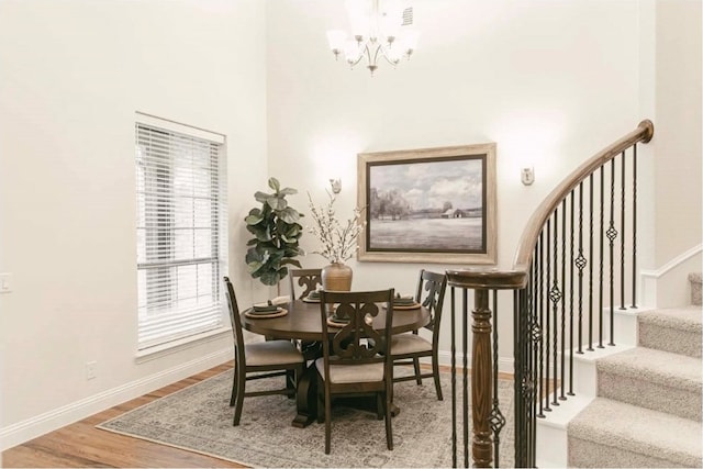 dining room featuring hardwood / wood-style floors and a chandelier