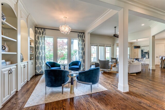 living room featuring ornamental molding, ceiling fan with notable chandelier, and hardwood / wood-style floors