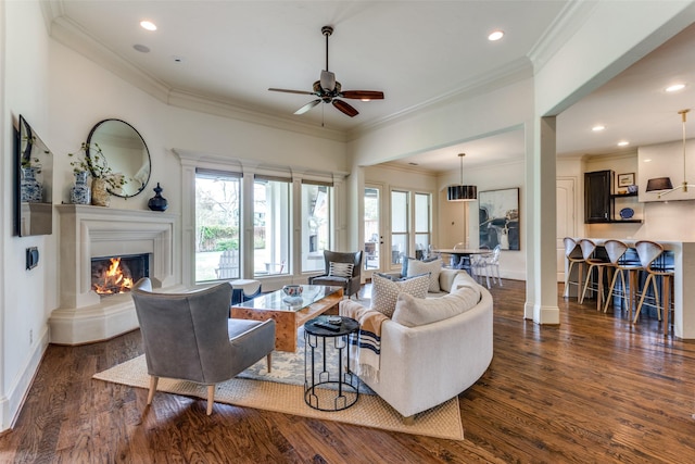 living room with ceiling fan, ornamental molding, dark hardwood / wood-style floors, and ornate columns