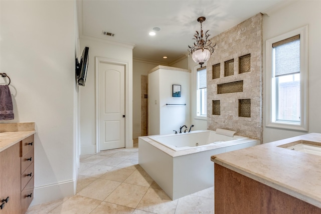 bathroom with tile patterned flooring, crown molding, vanity, and a bathtub