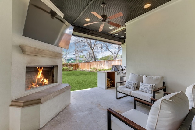 view of patio / terrace with an outdoor fireplace, an outdoor kitchen, area for grilling, and ceiling fan