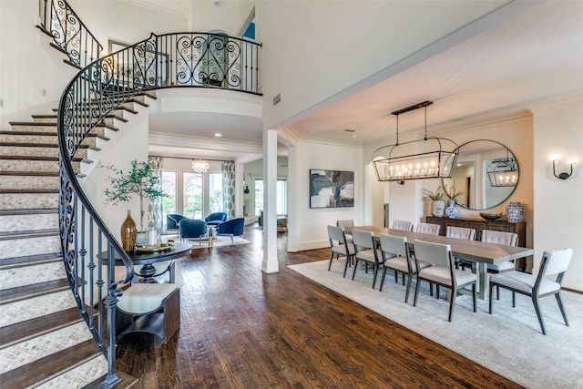 dining space with an inviting chandelier, hardwood / wood-style flooring, and ornamental molding