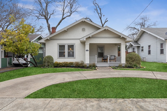 bungalow-style house featuring a front yard and a porch