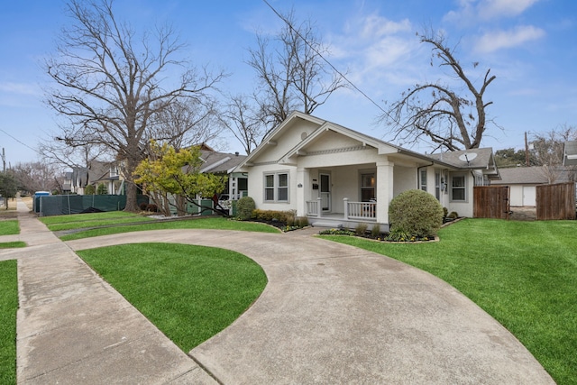 view of front of house featuring a front lawn and covered porch