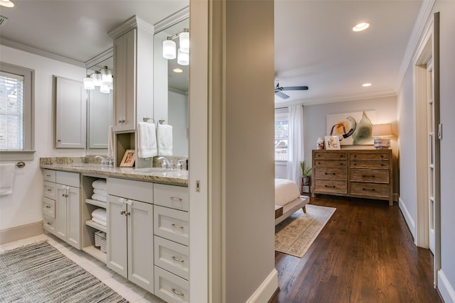 bathroom featuring crown molding, ceiling fan, vanity, and hardwood / wood-style flooring