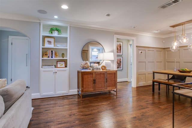 dining space featuring ornamental molding and dark hardwood / wood-style floors