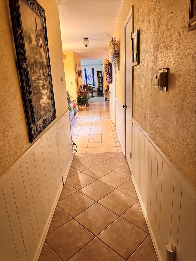 hallway with tile patterned flooring