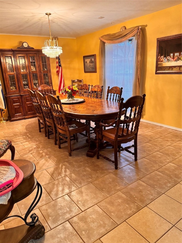 tiled dining space featuring an inviting chandelier