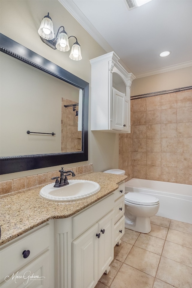 full bathroom with tiled shower / bath combo, vanity, toilet, crown molding, and tile patterned floors