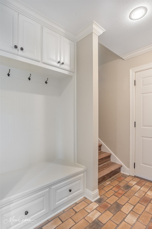 mudroom with a textured ceiling