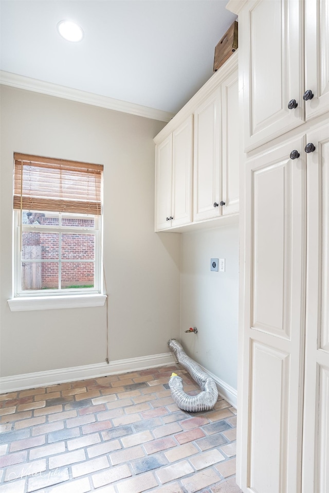 washroom with crown molding, cabinets, and electric dryer hookup