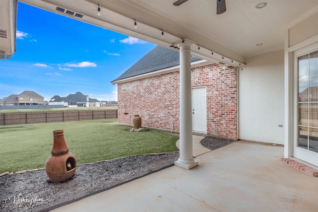 view of yard featuring a patio and ceiling fan