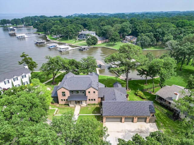 birds eye view of property with a water view