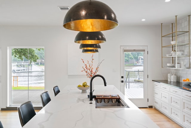 dining area featuring sink and light hardwood / wood-style flooring