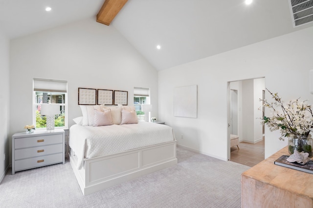 bedroom with light colored carpet, beam ceiling, and high vaulted ceiling