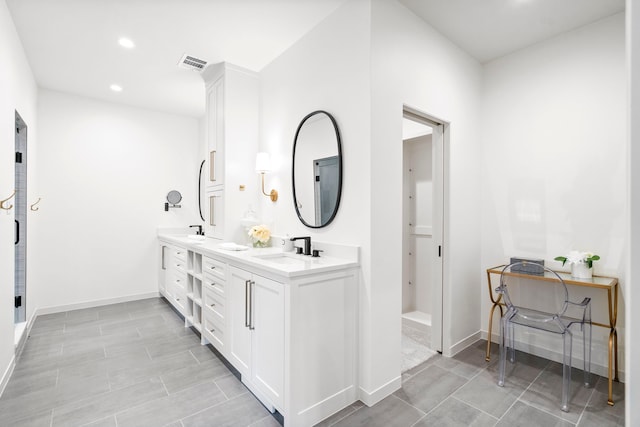 bathroom featuring vanity and a shower