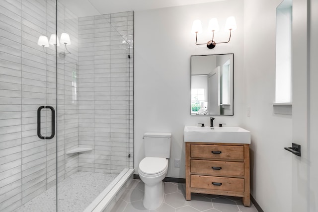 bathroom featuring walk in shower, toilet, vanity, a notable chandelier, and tile patterned flooring