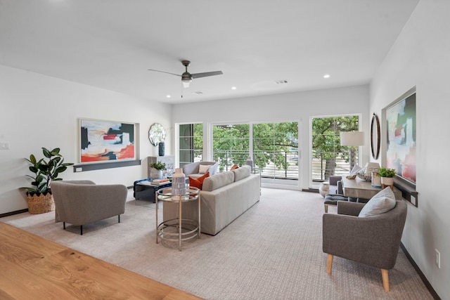 living room with ceiling fan and light hardwood / wood-style floors