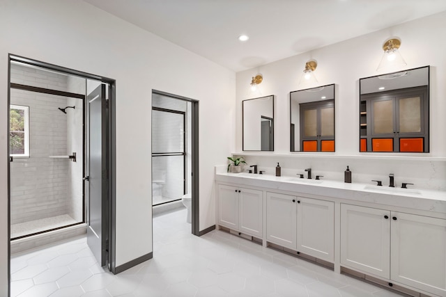 bathroom featuring tile patterned flooring, vanity, an enclosed shower, and toilet