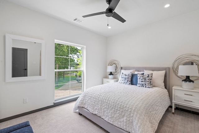 bedroom featuring light colored carpet and ceiling fan